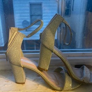 Silver rhinestone sandals buckle at the ankle